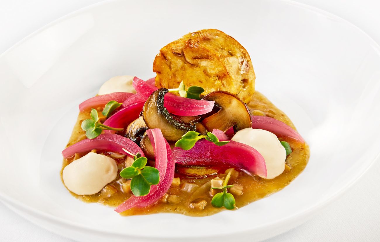 Die Vorspeise im PALAZZO Nürnberg: Nürnberger Breznknödel mit Nussbutterschaum, gebratenen Steinchampignons, Steinpilzvinaigrette, gepickelten roten Zwiebeln und Gartenkresse